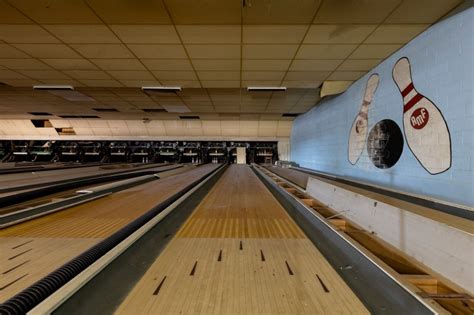 This old bowling alley was built in the early 1900's by Charles Sill. It was called "Tenpin" at that time. Eventually it became Beulah Bowling Center and was open many years. I found bowling results listed in the newspapers as late as 1999. By 2014, it was mostly demolished but part of the building remained as you can see from the comparison ...